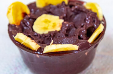 The most authentic Brazilian açaí, Euterpe oleracea, with banana in a minimalist bowl and compatible environment. Superfood energy and vitamins
