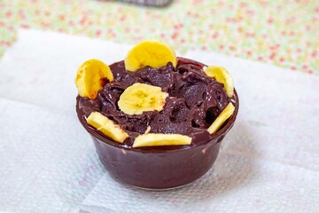 The most authentic Brazilian açaí, Euterpe oleracea, with banana in a minimalist bowl and compatible environment. Superfood energy and vitamins