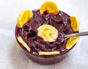 The most authentic Brazilian açaí, Euterpe oleracea, with banana in a minimalist bowl and compatible environment. Superfood energy and vitamins