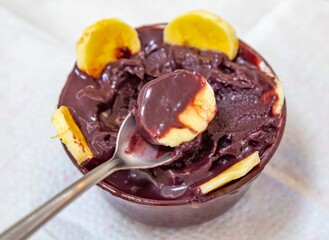 The most authentic Brazilian açaí, Euterpe oleracea, with banana in a minimalist bowl and compatible environment. Superfood energy and vitamins