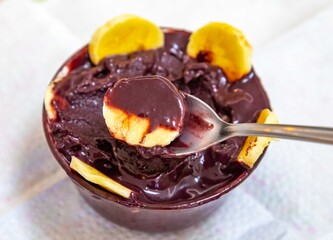 The most authentic Brazilian açaí, Euterpe oleracea, with banana in a minimalist bowl and compatible environment. Superfood energy and vitamins