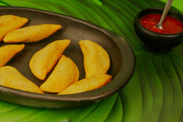 Delicious traditional Colombian empanadas with spicy sauce