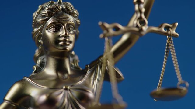 Video Statue of Justice with Scales and Law on a Blue Backdrop