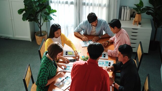 Top view of developer team designing Ux Ui design for phone interface or planning for making digital development. Startup project send develop plan to manager while sitting at boardroom. Convocation. - Powered by Adobe