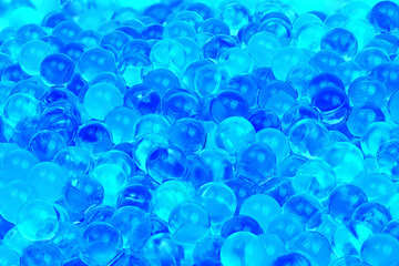 A blue background with many small blue spheres