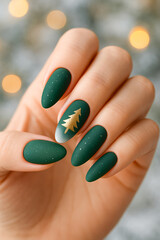A close-up of deep green matte nails featuring tiny white specks and a gold Christmas tree accent on one nail, ideal for holiday manicure inspiration and festive season campaigns. 