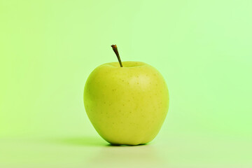 A green apple sits on a light green background