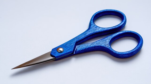 Blue scissors on a white background with sharp edges and smooth grip for crafting and office use