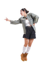 Confident Young Woman Pointing: A stylish young woman points with confidence. showcasing her fashionable ensemble against a clean backdrop, embodying empowerment.