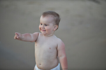 Fototapeta premium Happy 3-year-old boy enjoying the sea