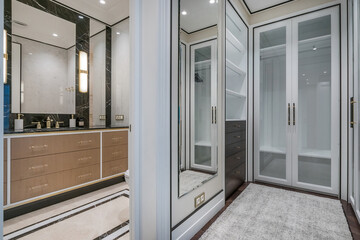 Modern bathroom and wardrobe design with elegant finishes and stylish storage solutions in a modern space.