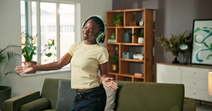 Dance, music and happy with black woman in home for streaming service, song playlist and energy. Headphones, audio subscription and connection with person in living room of house for radio and album
