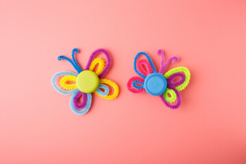 Colorful butterfly crafts using pipe cleaners and plastic caps, eco recycling activity for children, creative handmade project for education, art, zero waste, school workshop, learning material,