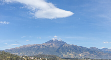 Fototapeta premium Panoramic view of the majestic Cotacachi volcano from the town of Otavalo, Ecuador. An Andean landscape that captures nature, serenity, and the cultural essence of the northern highlands.