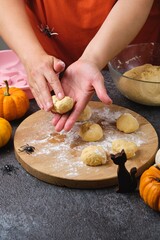 Step by step recipe for pumpkin bread shaped like a Halloween jack-o'-lantern on a dark concrete background. Halloween-themed baking. Holidays around the world.