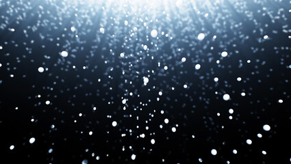 Falling white particles against dark background with light rays abstract bokeh