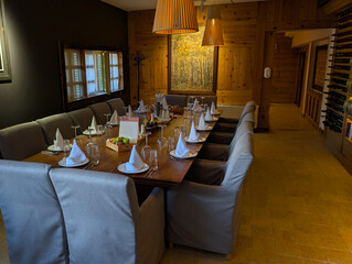 Reserved rustic dining table with portrait on wall. Heritage, tradition, hospitality and cultural dining environment.