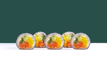 Salmon maki sushi roll with cucumber and takuan

Traditional japanese maki roll with salmon and vegetables

Classic maki sushi with salmon, cucumber and yellow radish
