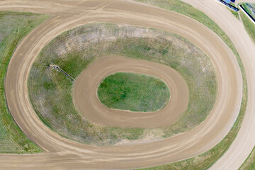 Drone aerial photograph of a section of a large oval shaped dirt speedway race track in regional NSW, Australia.