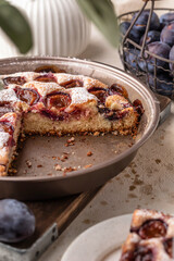 Homemade The New York Times plum cake. Sliced summer or autumn fruit pie in baking dish. Home cooking, recipe