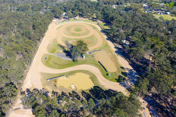 Drone aerial photograph of the Nepean Raceway speedway dirt track surrounded by trees and bushland in the greater Penrith region of NSW, Australia.
