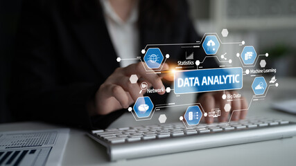 A professional dressed in a business suit interacts with a digital data analytics interface, showcasing trends, statistics, and machine learning elements in a modern office setting. Tessel