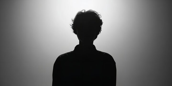 Intriguing silhouette of a person against a gradient backdrop creates a mysterious and dramatic mood