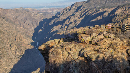 A woman at an over look viewing the impressive Black Canyon of the Gunnison near Montrose, Colorado