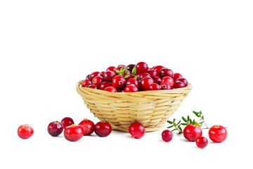 Cranberries in a wicker basket isolated on a white background.