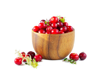 Cranberries in a wooden bowl isolated on a white background.