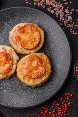 Round fish or chicken cutlets baked with tomato and cheese. Fish cutlets