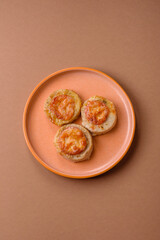 Round fish or chicken cutlets baked with tomato and cheese. Fish cutlets