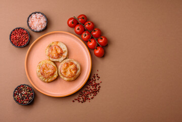 Round fish or chicken cutlets baked with tomato and cheese. Fish cutlets
