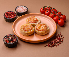 Round fish or chicken cutlets baked with tomato and cheese. Fish cutlets