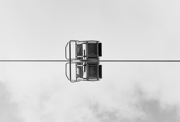 old skilift chair from underneath in black and white and a strong shillouette