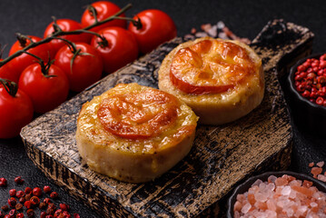 Round fish or chicken cutlets baked with tomato and cheese. Fish cutlets