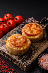 Round fish or chicken cutlets baked with tomato and cheese. Fish cutlets