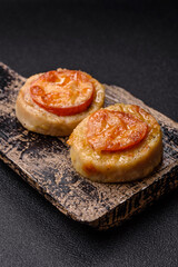 Round fish or chicken cutlets baked with tomato and cheese. Fish cutlets