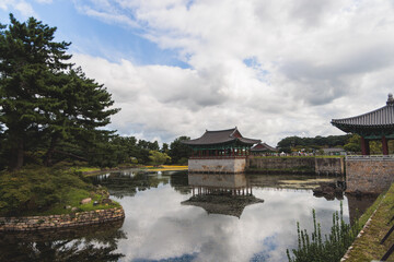 Naklejka premium Gyeongju, South Korea, view of Donggung Palace and Wolji Pond in a sunny day, North Gyeongsang Province, Gyeongju city, Silla dinasty traditional Korean hanok architecture, Yeongnam region