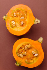 Half a raw pumpkin, a ripe orange colored butternut squash. Raw pumpkin