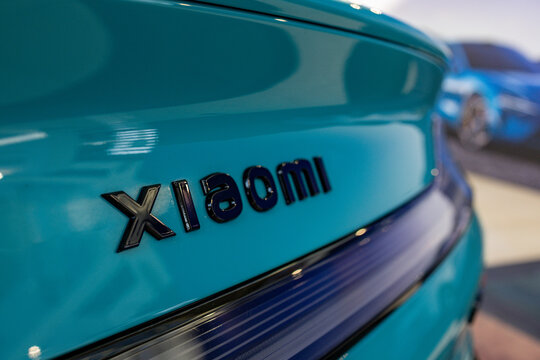 Warsaw, Poland &ndash; October 4, 2025: Close-up view of the Xiaomi logo on the rear of the Xiaomi SU7 electric car displayed in a showroom during an automotive event.