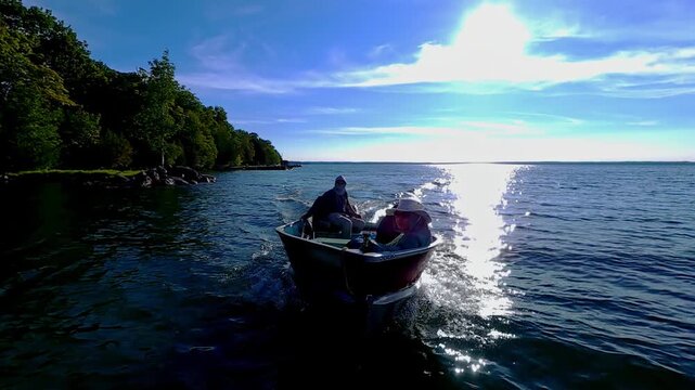 Fishermen on vacation, boating in lake Manitou, Manitoulin Island, Ontario, Canada. End of fishing game tournament. Water sport at fall. Power sport fishing and watersport.