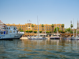 LUXOR, EGYPT : View of Luxor city along the Nile River with the historic Winter Palace Hotel in the foreground, a place famously associated with Agatha Christie.