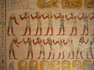 VALLEY OF THE KINGS, EGYPT : Interior of a tomb in the Valley of the Kings, featuring intricate wall paintings and hieroglyphs that tell stories of ancient Egyptian pharaohs.