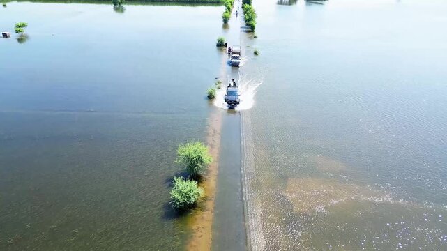 Flooded Fields and Roads in Pakistan &ndash; Aerial Drone Shot
Car driving in water,Drone View of Submerged Town in Pakistan during Floods