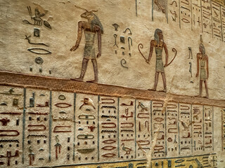 VALLEY OF THE KINGS, EGYPT : Interior of a tomb in the Valley of the Kings, featuring intricate wall paintings and hieroglyphs that tell stories of ancient Egyptian pharaohs.