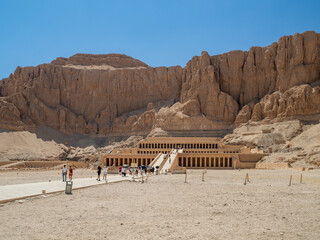 LUXOR, EGYPT : The Mortuary Temple of Hatshepsut at Valley of the Queens, an impressive ancient Egyptian monument built into limestone cliffs, visited by travelers from around the world.