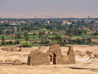 LUXOR, EGYPT : A panoramic view of Luxor’s city skyline along the Nile River, with sunlight reflecting on the water and the city’s historical architecture visible in the background.