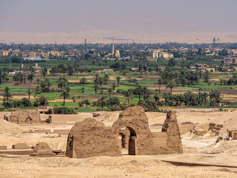 LUXOR, EGYPT : A panoramic view of Luxor’s city skyline along the Nile River, with sunlight reflecting on the water and the city’s historical architecture visible in the background.