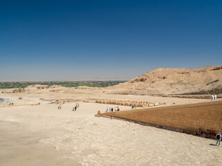 LUXOR, EGYPT : The Mortuary Temple of Hatshepsut at Valley of the Queens, an impressive ancient Egyptian monument built into limestone cliffs, visited by travelers from around the world.